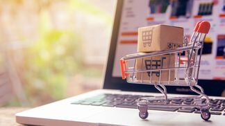 shopping-online-concept-parcel-or-paper-cartons-with-a-shopping-cart-logo-in-a-trolley-on-a-laptop-keyboard-shopping-service-on-the-online-web-offers-home-delivery